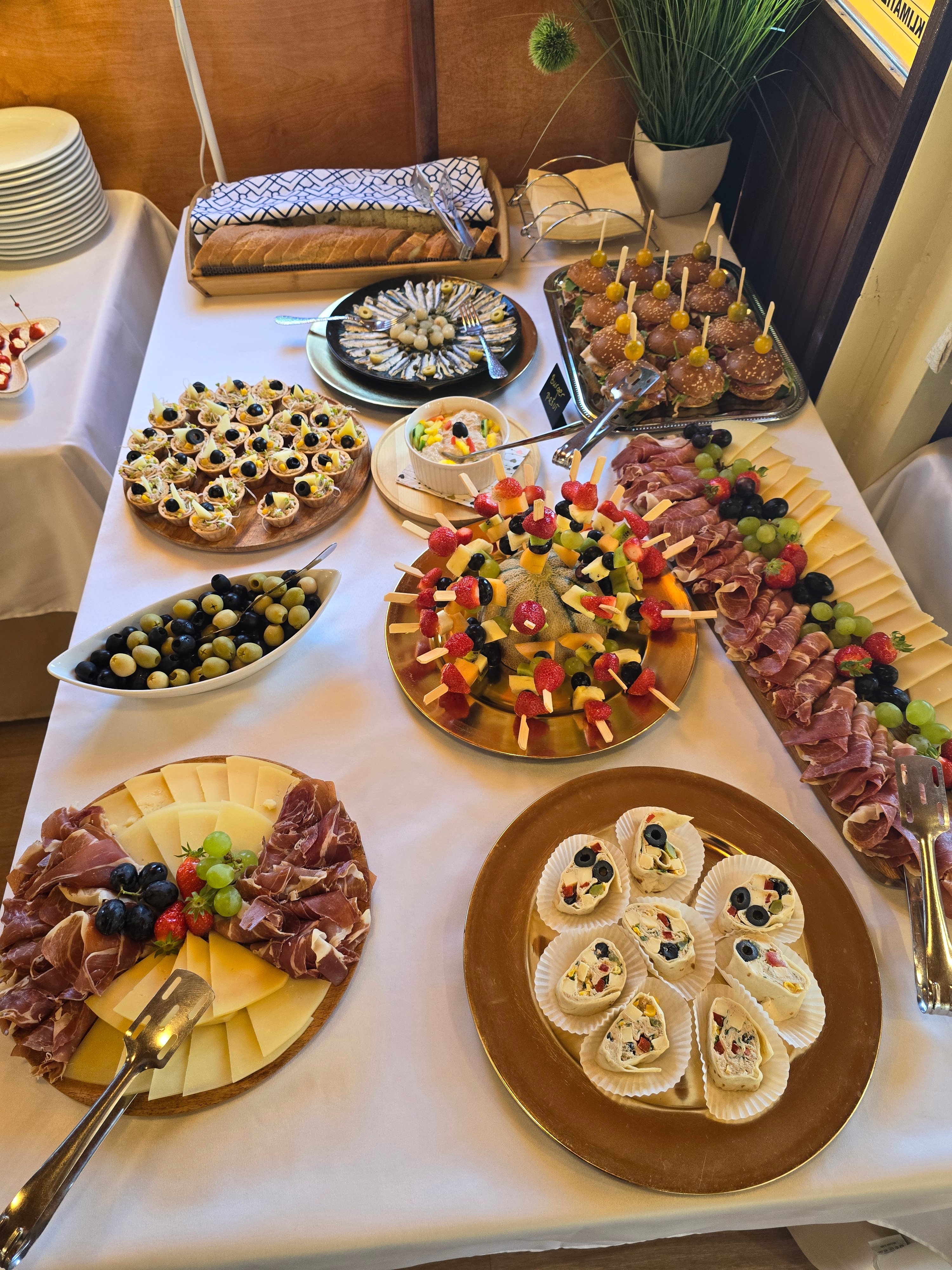 Elaborate spread of canapés, mini burgers, fruit skewers and charcuterie platters