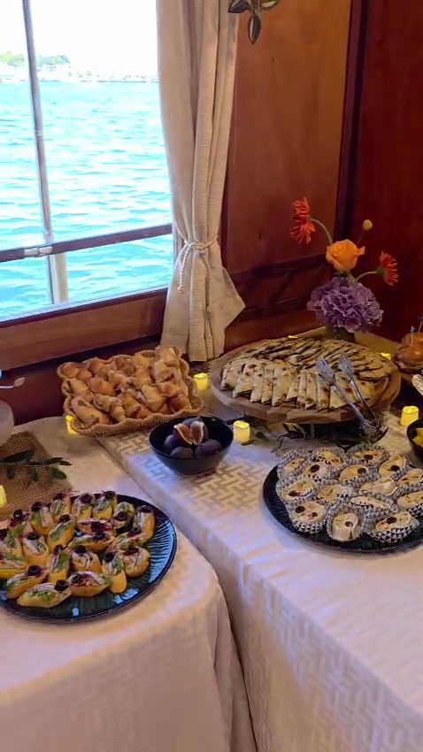 Buffet table of soparnik, canapés and pastries dressed with fresh flowers aboard Polaris