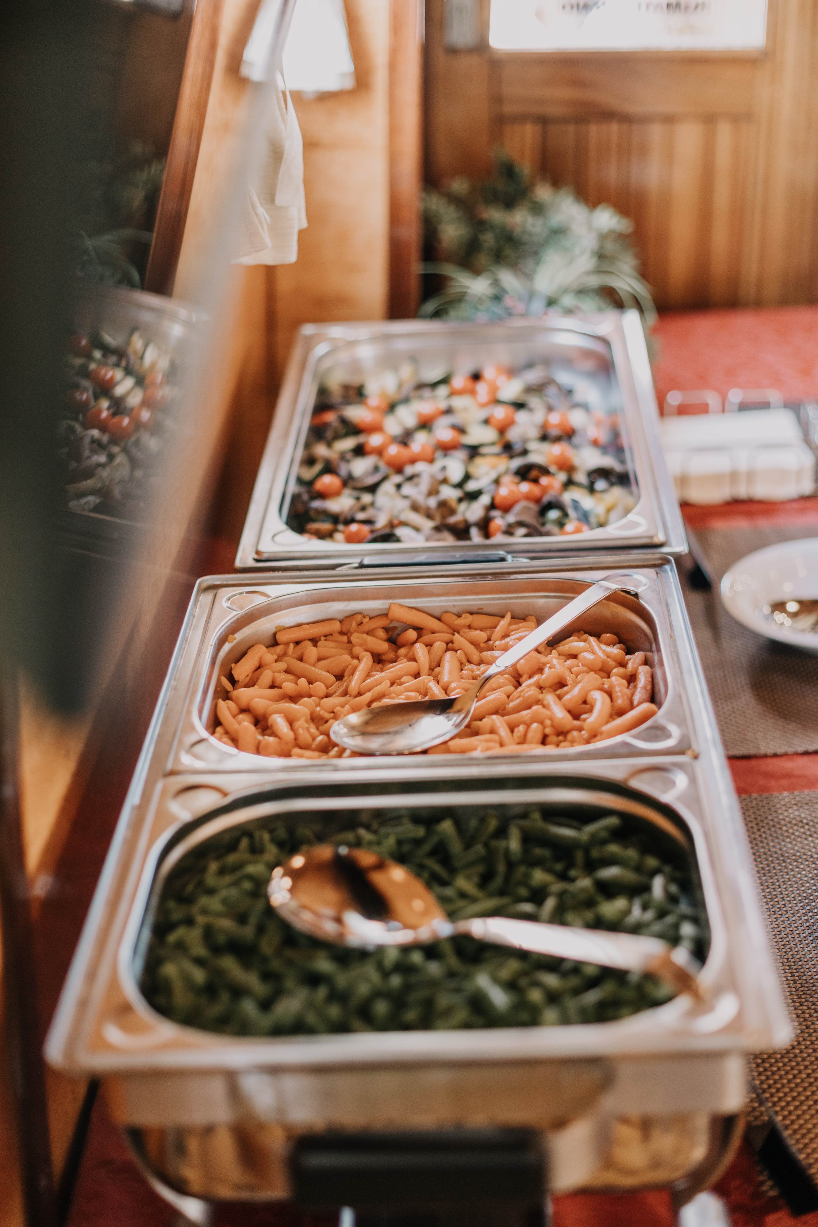 Roasted Mediterranean vegetables, pasta and green beans in a buffet line