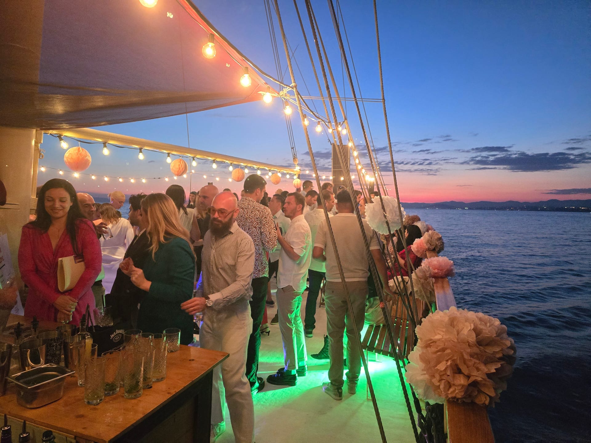 Evening deck gathering with string lights and a cocktail bar on Polaris