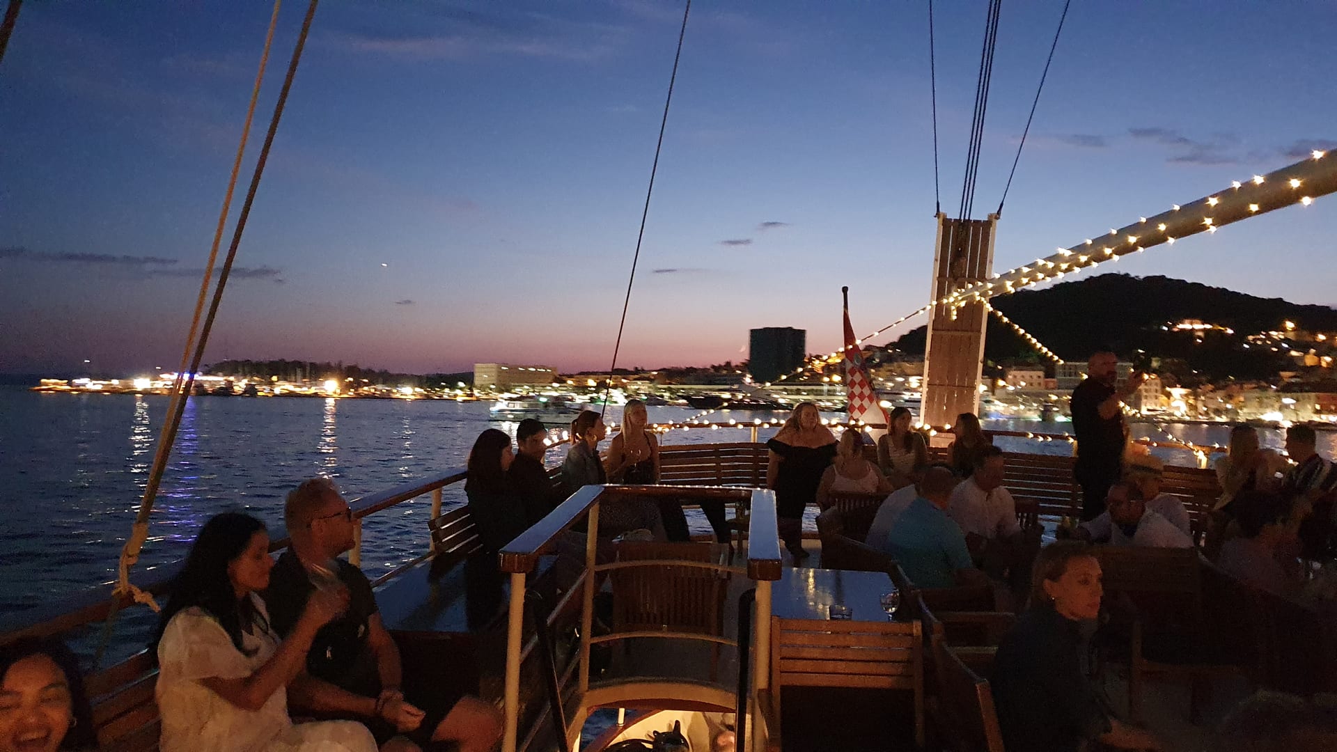 Polaris deck strung with fairy lights as guests enjoy the evening