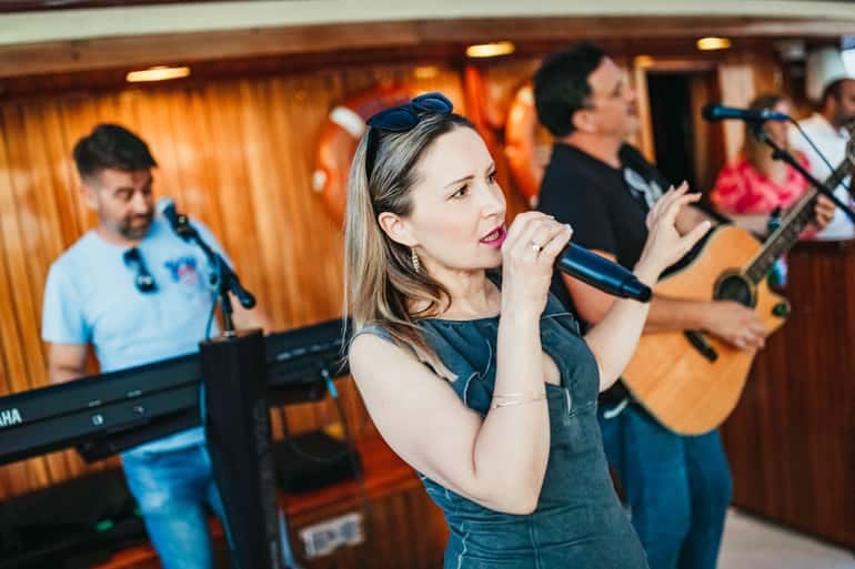 Singer performing with the live band on board