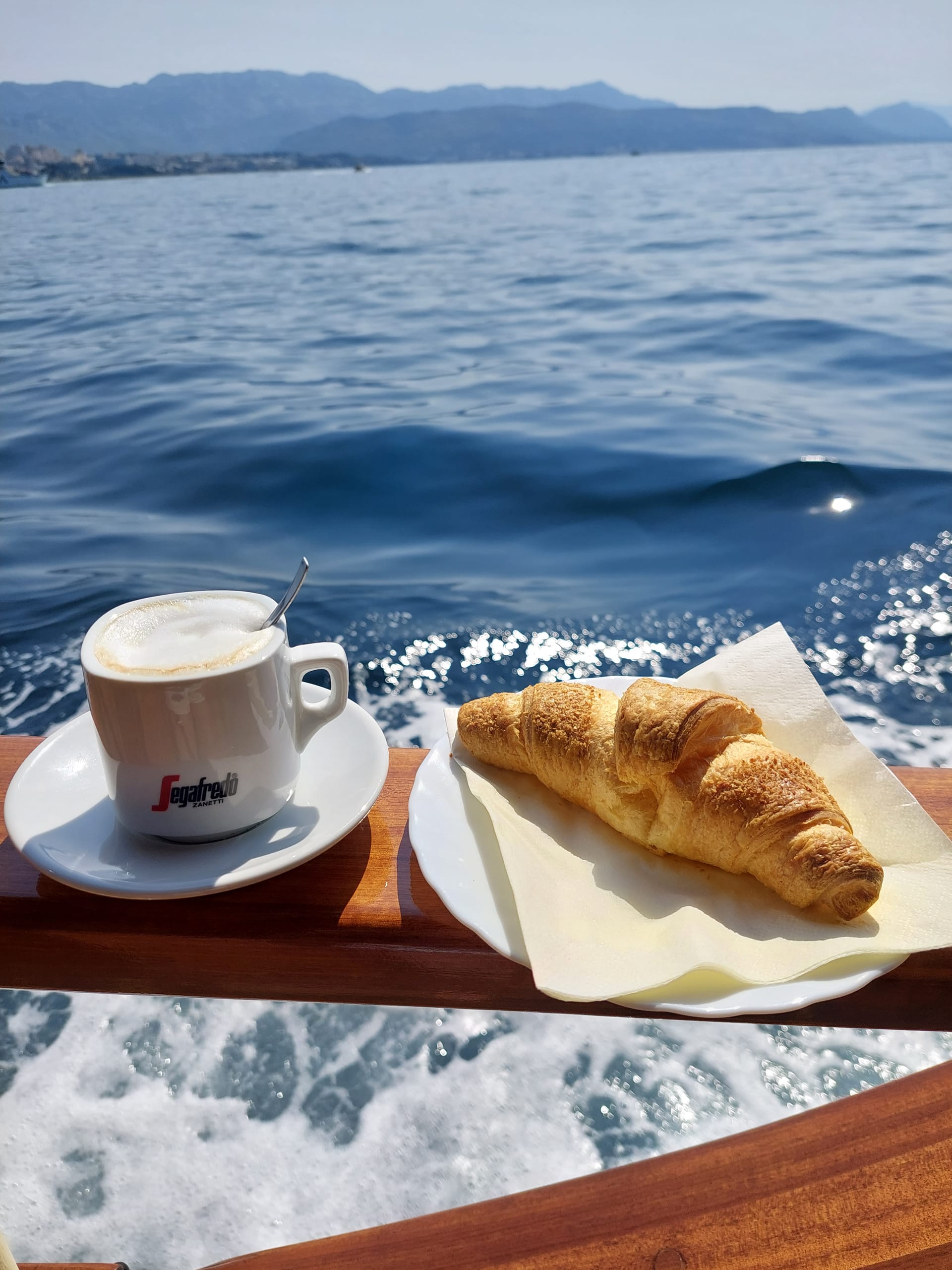 Welcome coffee and croissant served on the deck rail